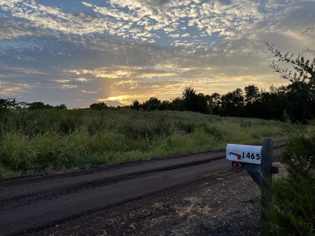 Country road and sunset near the farm